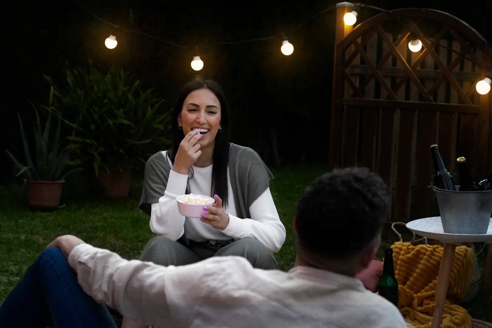 Family enjoying a backyard outdoor living space in Aubrey, TX in the evening