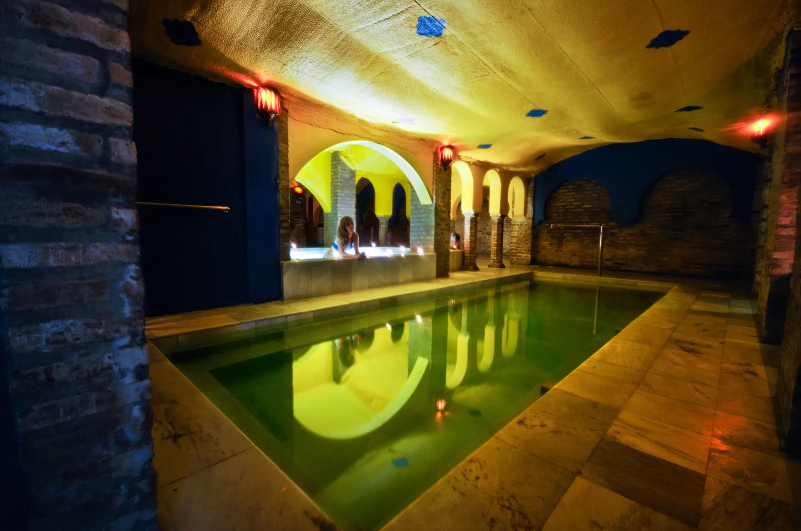 Backyard swimming pool in Pilot Point, TX at dusk with warm landscape lighting